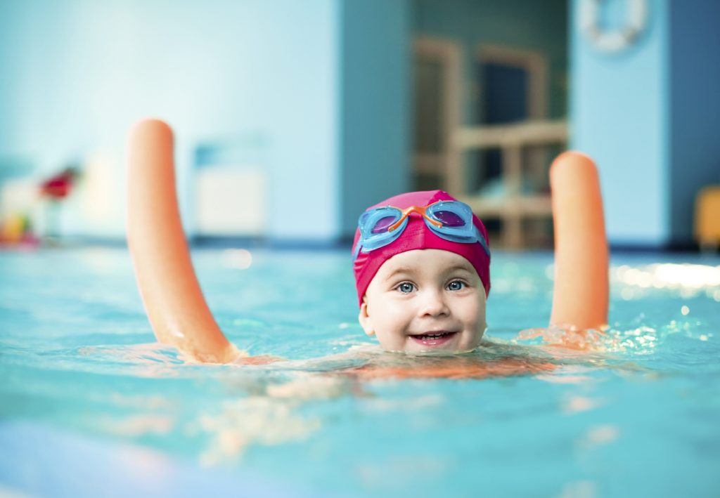 Child with swimming aid