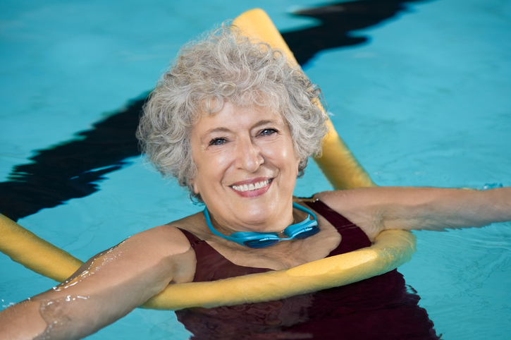 Elderly lady with swimming aid