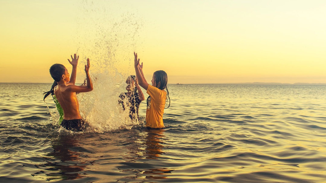 Children playing in the sea